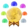 A collage of a moon-shaped lamp in various colors, displayed on a wooden stand. Podgląd zdjęcia produktu