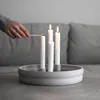 A hand lighting candles on a candle holder. Produktbild-Vorschau