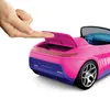 A finger is shown pressing down on the open trunk of a pink and blue toy car. Náhľad obrázku produktu