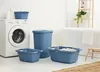 A laundry room scene with a washing machine, bathtub, and several blue laundry baskets. Náhled obrázku produktu