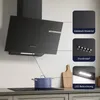 A black angled range hood is shown above a black induction cooktop with a blue pot on it. The image includes callouts highlighting the stainless steel material, push buttons, and LED lighting. Voir les images du produit