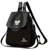 A black leather backpack with a Mickey Mouse-like emblem on the flap and a kangaroo logo on the front. Podgląd zdjęcia produktu