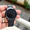 A hand holding a black watch. Anteprima dell’immagine prodotto