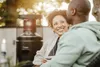 A couple enjoying time outdoors next to a patio heater. Produktbild-Vorschau
