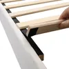 A close-up view of a bed frame's wooden slats and upholstered side. Náhľad obrázku produktu