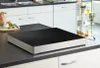A modern kitchen countertop with a sleek induction cooktop. Anteprima dell’immagine prodotto