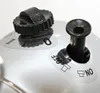 A close-up view of two control knobs and labels on a white appliance. Produktbild-Vorschau