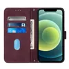 A brown leather flip case for an iPhone 12, showing the inside with card slots and a bill compartment, and the phone displaying its screen. Produktbild-Vorschau