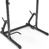 A black metal squat rack with dip station attachments, shown from a low angle against a white background. Produktbild-Vorschau