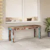A rustic wooden bench is placed on a tiled patio in front of a window with white blinds. Voir les images du produit
