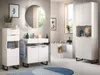 A modern bathroom with white vanity, sink, mirror, and storage cabinets, featuring a bathtub and a window with greenery outside. Produktbild-Vorschau