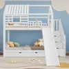 A white bunk bed with a slide and stairs, set against a light blue wall with cloud decorations. Produktbild-Vorschau
