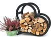 A black metal heart-shaped log holder filled with firewood, next to a potted plant with pink flowers. Podgląd zdjęcia produktu