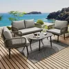 A patio set on a wooden deck overlooking the ocean. Podgląd zdjęcia produktu