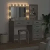 A vanity table with a mirror and shelves, illuminated by lights around the mirror. Voir les images du produit