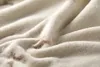 A close-up view of a soft, textured blanket with a subtle pattern. Produktbild-Vorschau