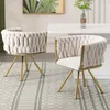 Two beige upholstered chairs with gold legs are placed on a rug in front of a white dining table. Produktbild-Vorschau