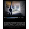 A person stands in a dark hallway, illuminated by a flashlight beam. Produktbild-Vorschau