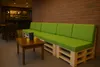 A seating area with a pallet sofa and a coffee table in front of a brick wall. Produktbild-Vorschau