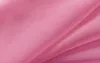A close-up of pink fabric with folds and creases. Produktbild-Vorschau