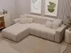 A sectional sofa in a living room setting with artwork on the wall. Produktbild-Vorschau