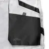 A close-up view of a pocket on a pair of white work pants. Produktbild-Vorschau
