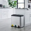 A modern kitchen with white cabinets and a stainless steel trash can with three compartments. Voir les images du produit