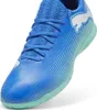 A close-up, studio shot of a blue Puma soccer shoe with white accents and a light green sole. Náhľad obrázku produktu