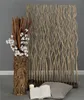 A room divider made of natural branches is shown in a studio setting with decorative elements. Náhľad obrázku produktu