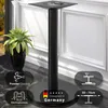 A black metal bistro table base with a round foot and a square top plate, placed on a marble-like surface next to a potted plant. Informational graphics are overlaid on the image. Produktbild-Vorschau