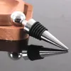 A close-up shot of a wine bottle stopper on a reflective surface, with a wooden object in the background. Anteprima dell’immagine prodotto