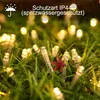 Fairy lights in grass during rain. Produktbild-Vorschau