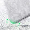 A close-up of a gray laptop bag corner hitting the ground, with green arrows indicating shock absorption. Náhled obrázku produktu