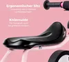 Close-up of a pink balance bike seat and handlebars with German text describing features. Voir les images du produit