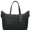 A studio shot of a black GUESS shopper bag with a repeating logo pattern. Produktbild-Vorschau