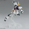A white and blue Gundam model figure is posed dynamically on a clear plastic stand against a light gray background. Anteprima dell’immagine prodotto