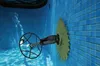 A pool cleaner is attached to the wall of a tiled swimming pool. Produktbild-Vorschau