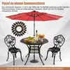 A garden table and chairs set with a red umbrella, food, and drinks on the table. Produktbild-Vorschau