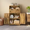 A wooden bathroom cabinet with doors and drawers, filled with toiletries and towels. Produktbild-Vorschau