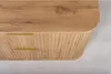 A close-up view of a wooden bathroom vanity with two drawers and gold handles. Produktbild-Vorschau