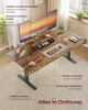 A modern standing desk with multiple monitors and accessories, set up in a home office environment. Produktbild-Vorschau