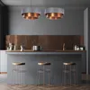 A modern kitchen with a breakfast bar, pendant lights, and stools. Podgląd zdjęcia produktu