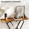A console table with decorative items on it, including a lamp, books, and a framed picture. Podgląd zdjęcia produktu