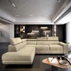 A modern living room with a sectional sofa, decorative wall, and coffee table. Produktbild-Vorschau