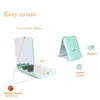 A mint green makeup mirror with LED lights is shown open and closed, with diagrams illustrating its features. Produktbild-Vorschau