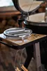 A close-up view of a grilling accessory on a side table of a grill. Produktbild-Vorschau