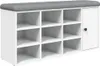 A white shoe bench with a gray upholstered top and multiple cubbies for storage, with one cabinet door on the right side. Náhled obrázku produktu