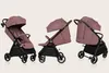 Three views of a rose-colored baby stroller against a light beige background. Produktbild-Vorschau