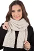 A woman wearing a beige scarf and black sweater against a white background. Anteprima dell’immagine prodotto