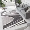 A modern living room with a gray sofa, a rug, and plants. Produktbild-Vorschau